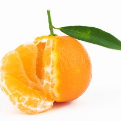 Fresh tangerine with leaves on white