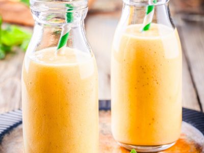 tropical smoothie in glass bottles with mango and banana